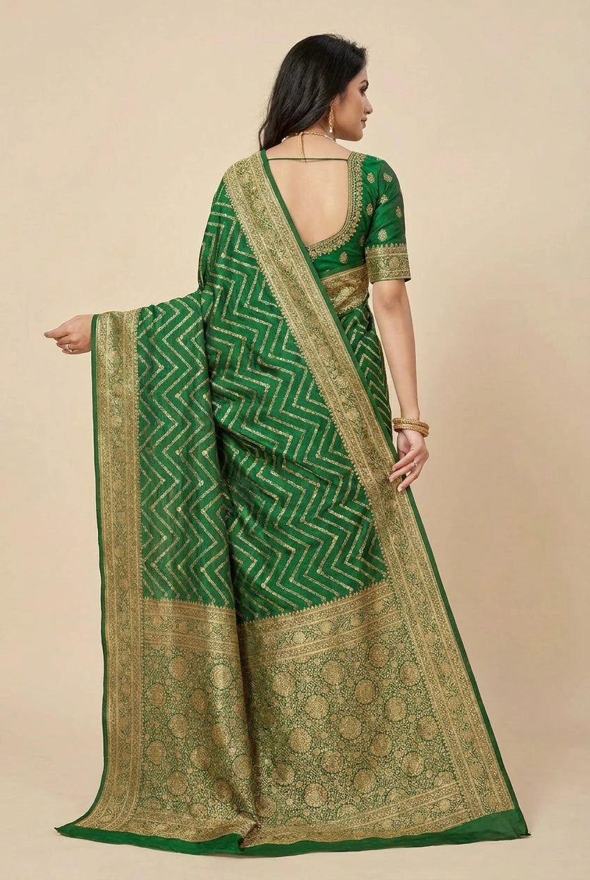 Woman wearing a green saree with gold border on a beige background