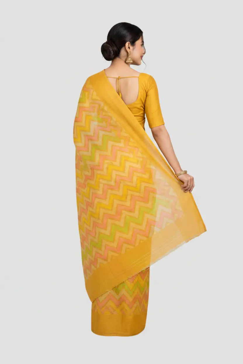 Woman wearing a yellow saree with a geometric pattern on a white background