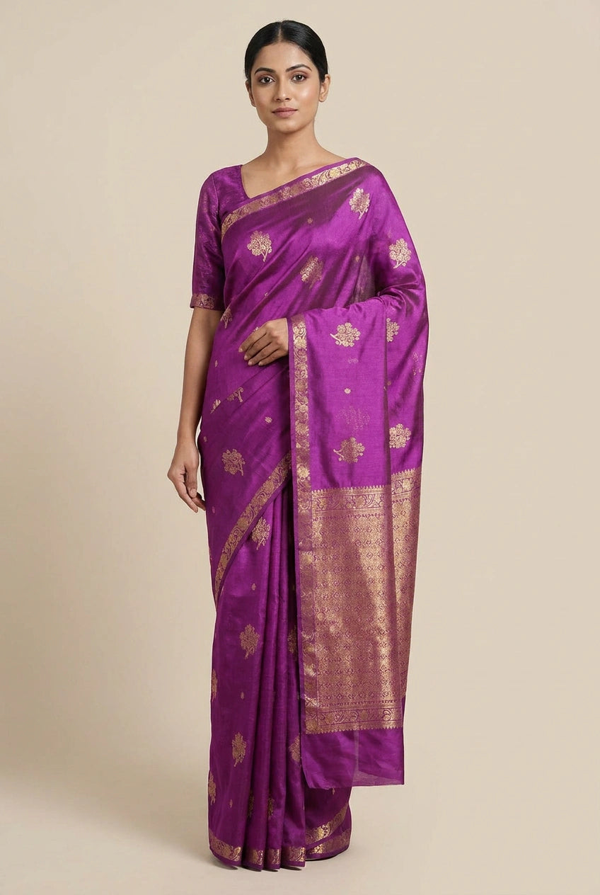Woman wearing a purple saree with gold patterns on a beige background