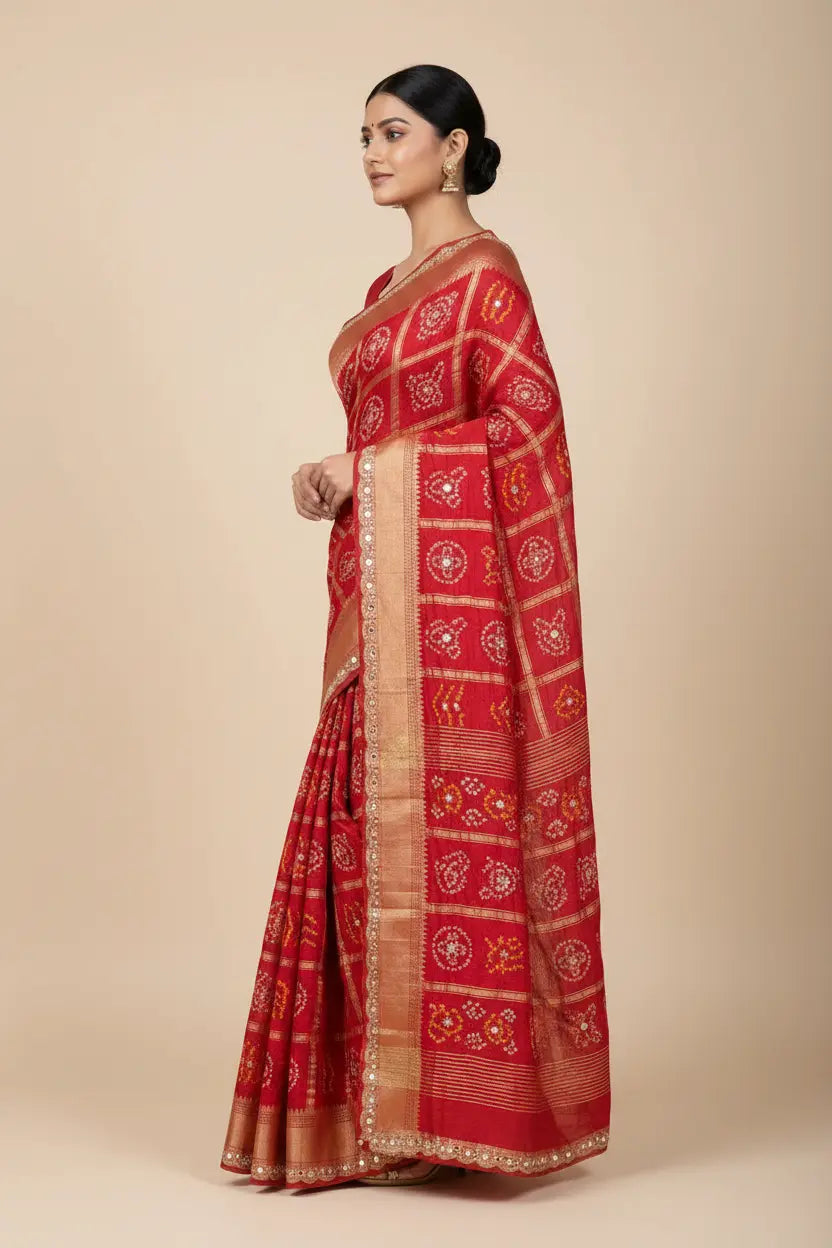 Woman wearing a red saree with a beige background