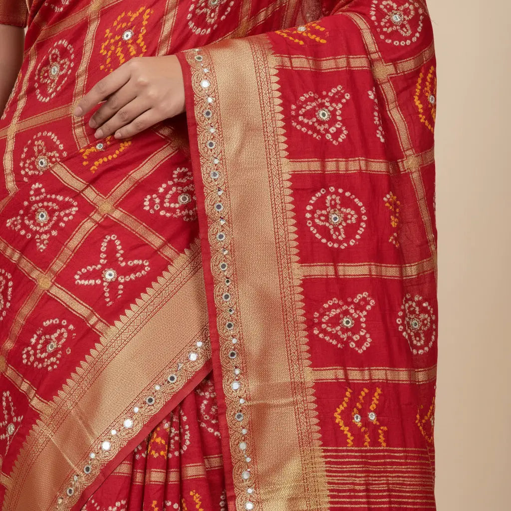 Red saree with gold patterns on a beige background