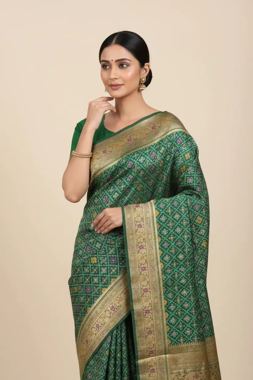 Woman wearing a green saree with gold patterns on a beige background