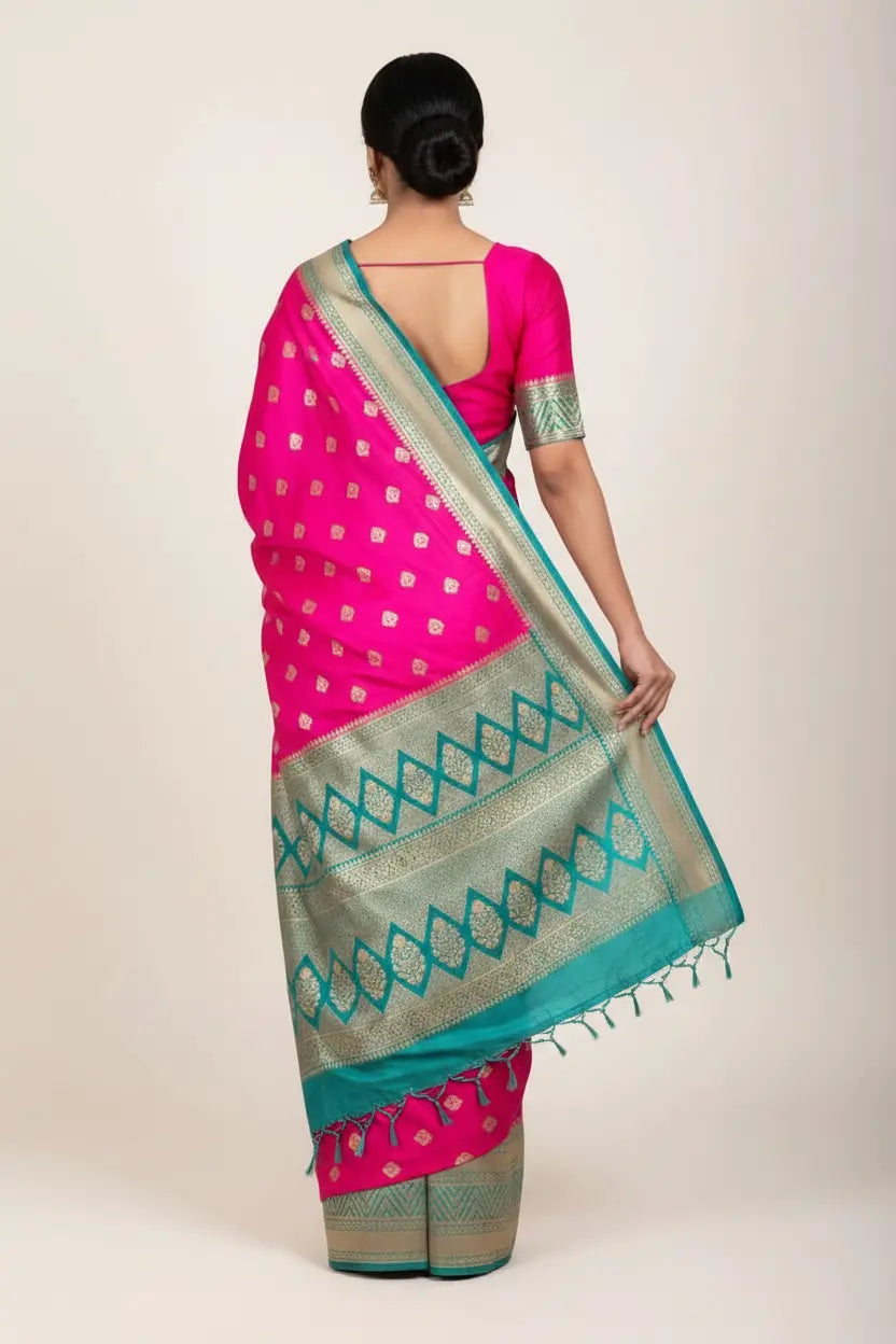 Woman wearing a pink and green saree with a white background