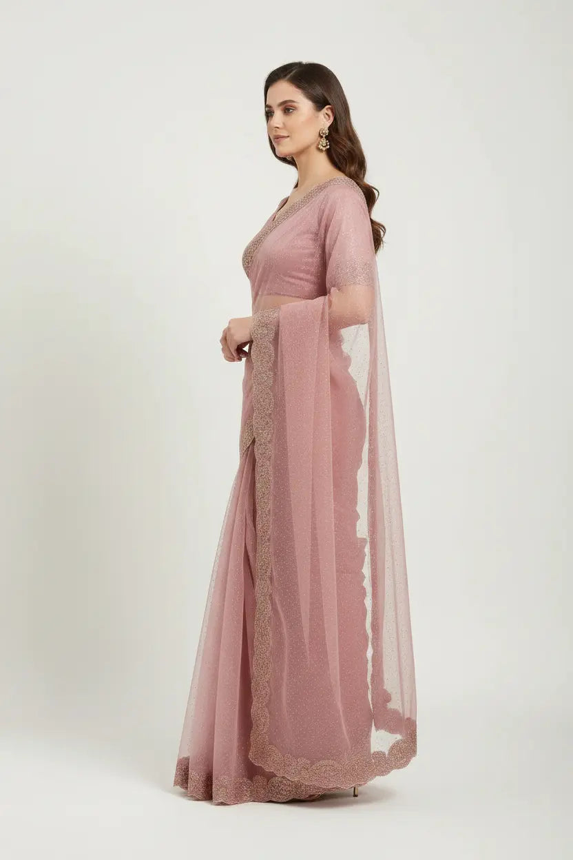 Woman wearing a pink saree with a white background