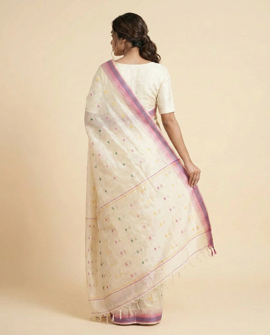 Woman wearing a cream saree with pink border on a beige background