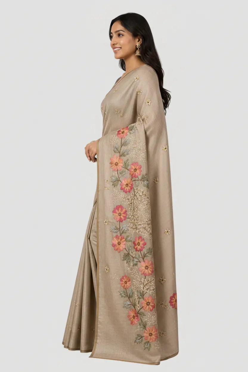 Woman wearing a beige embroidered dress on a white background