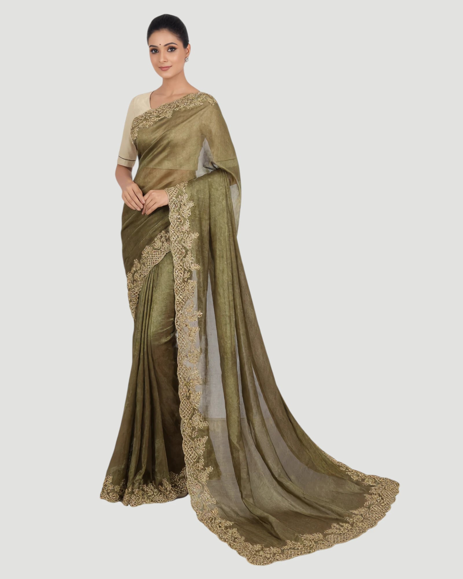 Woman wearing a green saree with white blouse on a white background