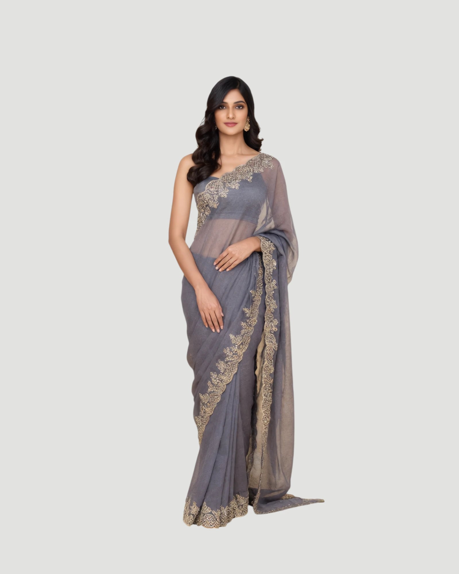 Woman wearing a gray saree with gold embroidery on a white background