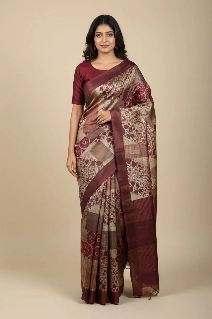 Woman wearing a patterned saree on a beige background