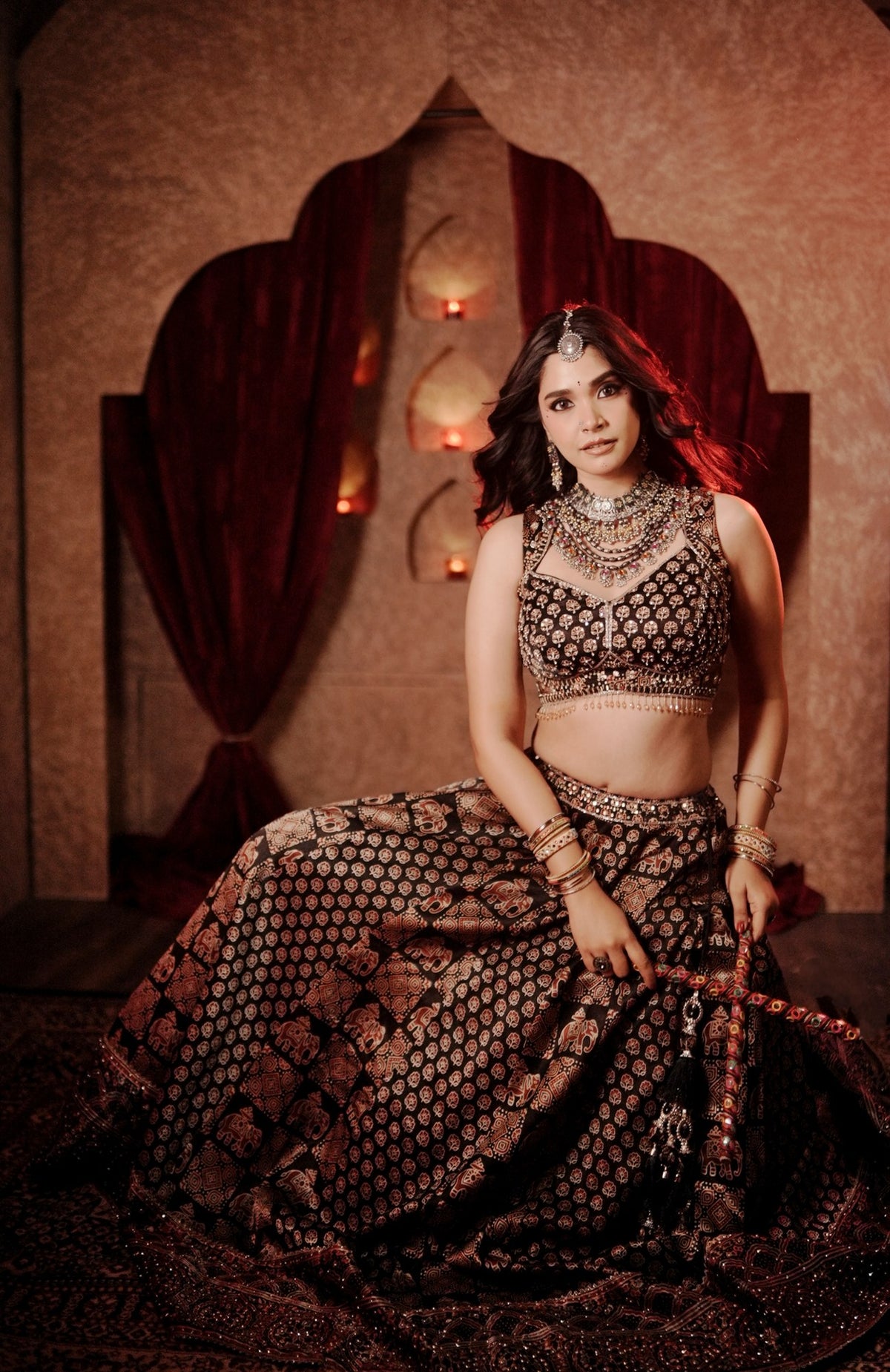 Black Ajrak print lehenga skirt spread out, seated
