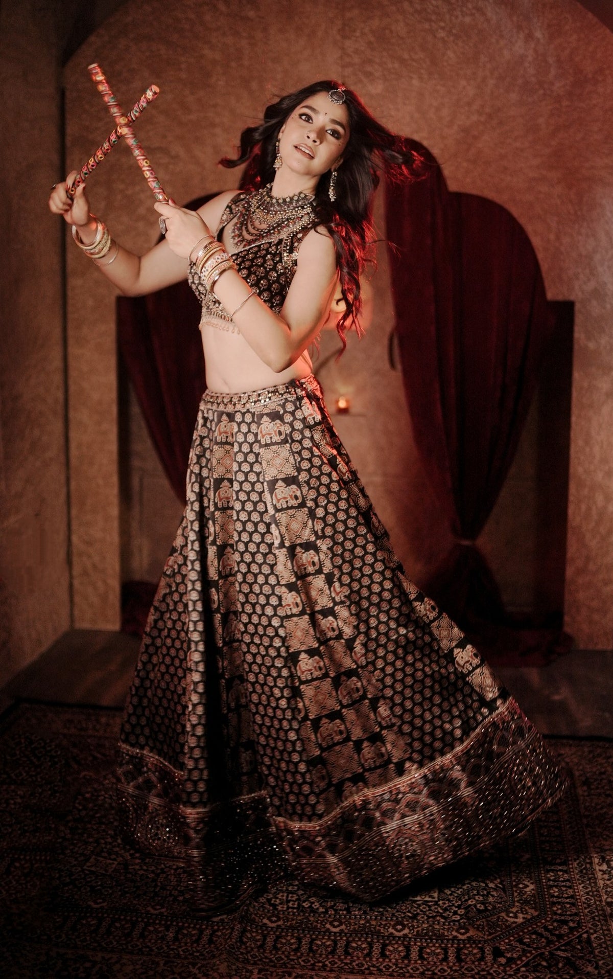 Black Ajrak print crop-top lehenga, dandiya pose