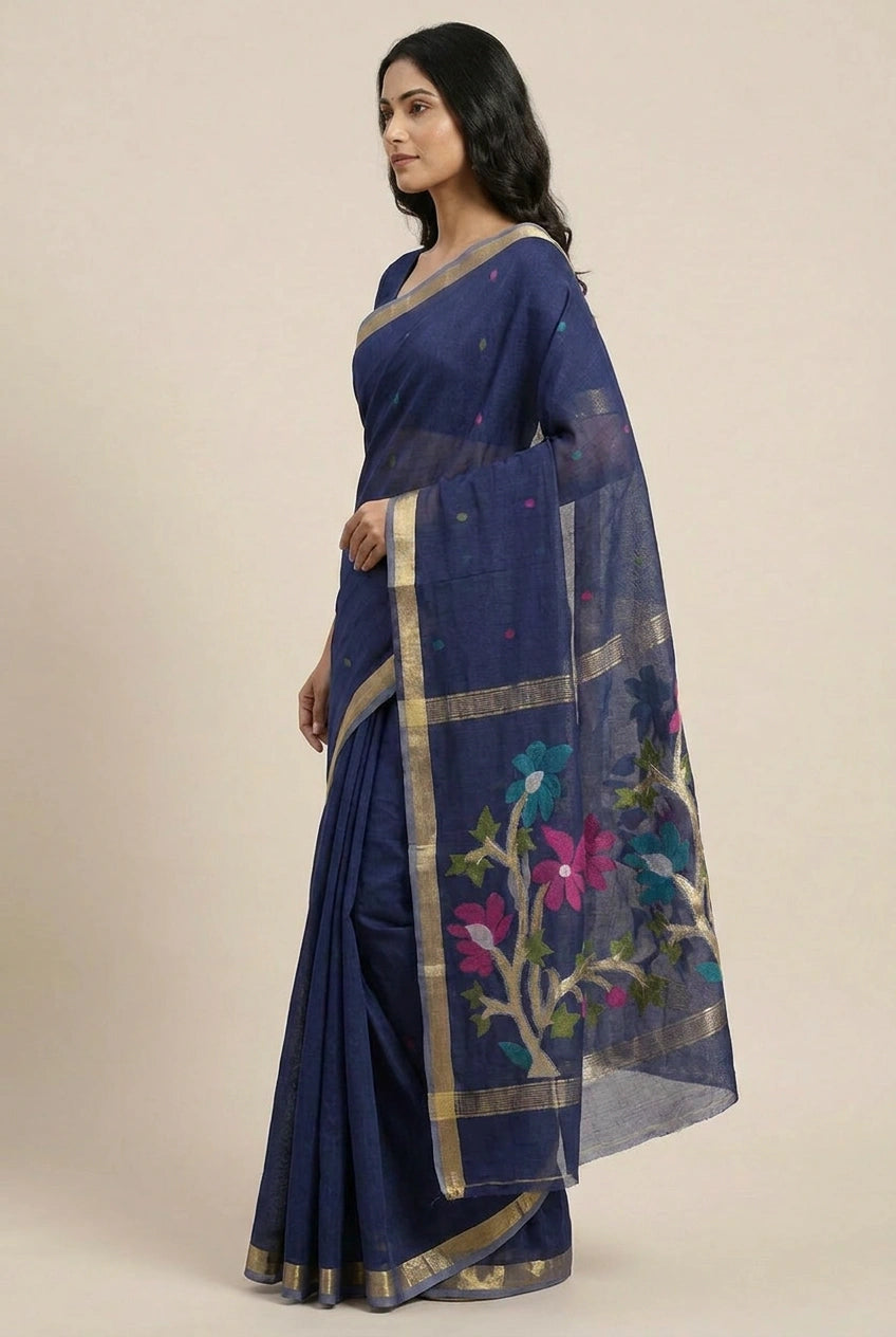 Woman wearing a blue saree with floral patterns on a beige background