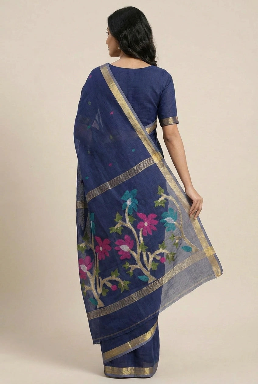 Woman wearing a blue saree with floral patterns on a beige background
