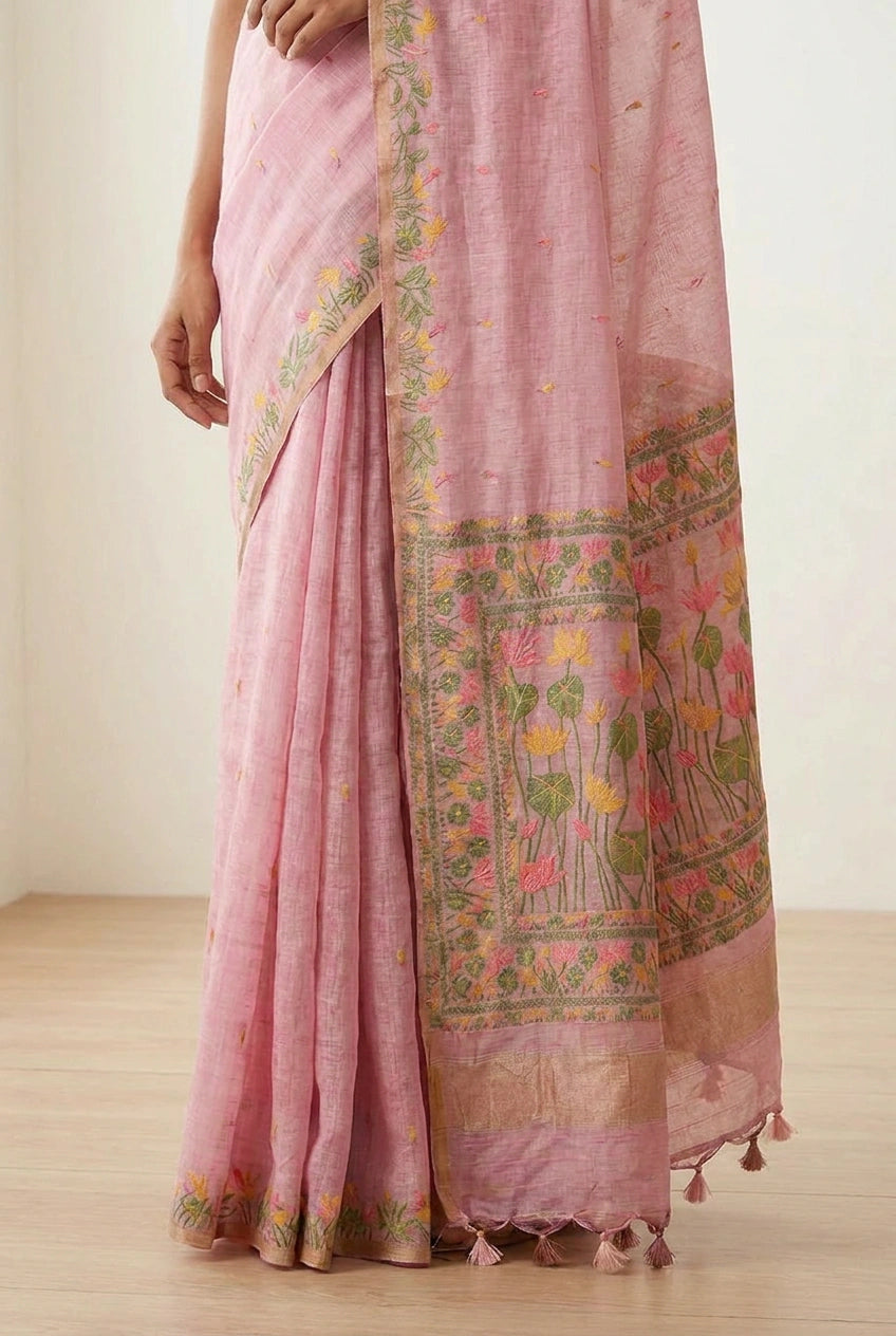 Pink saree with floral patterns on a wooden floor