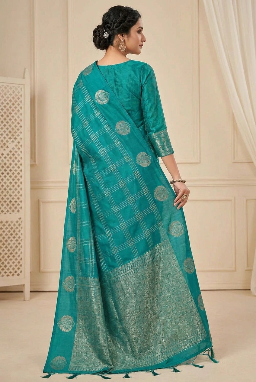 Woman wearing a teal saree with a white background