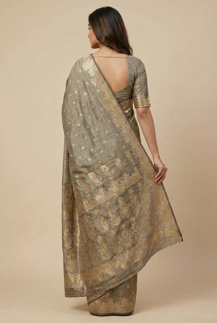 Woman wearing a traditional saree with a beige background