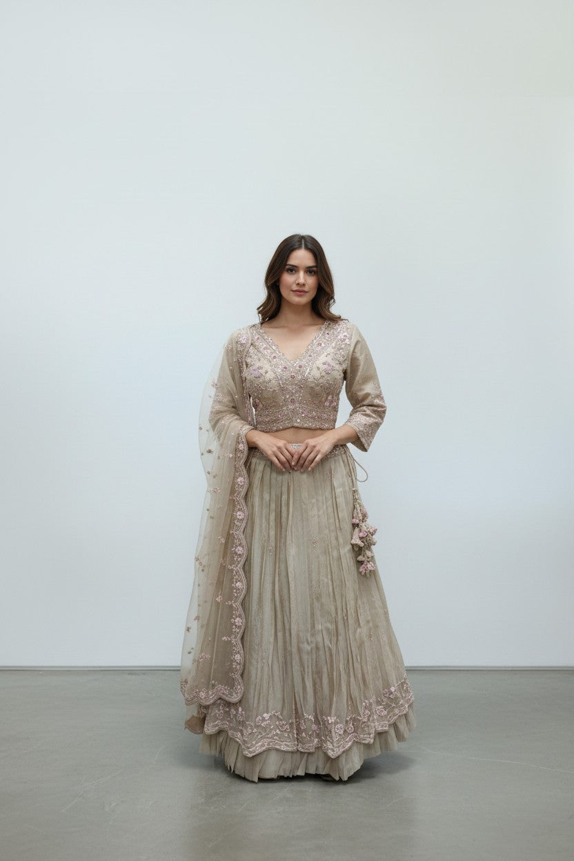 Rangoli beige silk lehenga choli with pink floral embroidery and matching dupatta. Elegant festive wear.