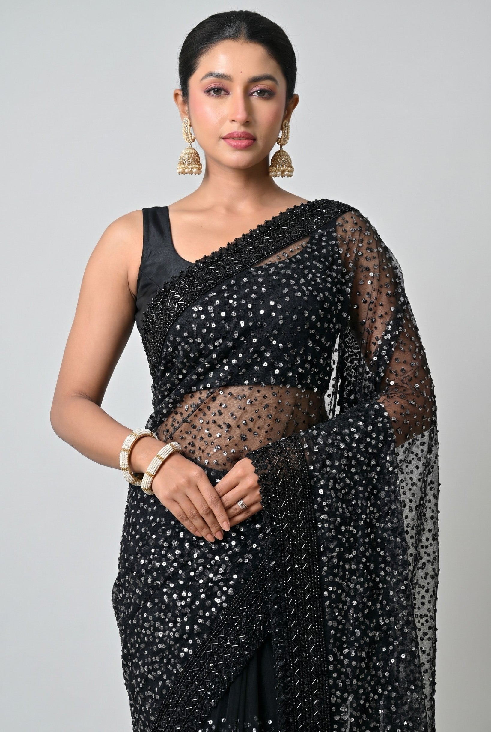 Rangoli black net saree embellished with shimmering sequins and intricate beadwork, paired with a matching blouse. Perfect for formal events.