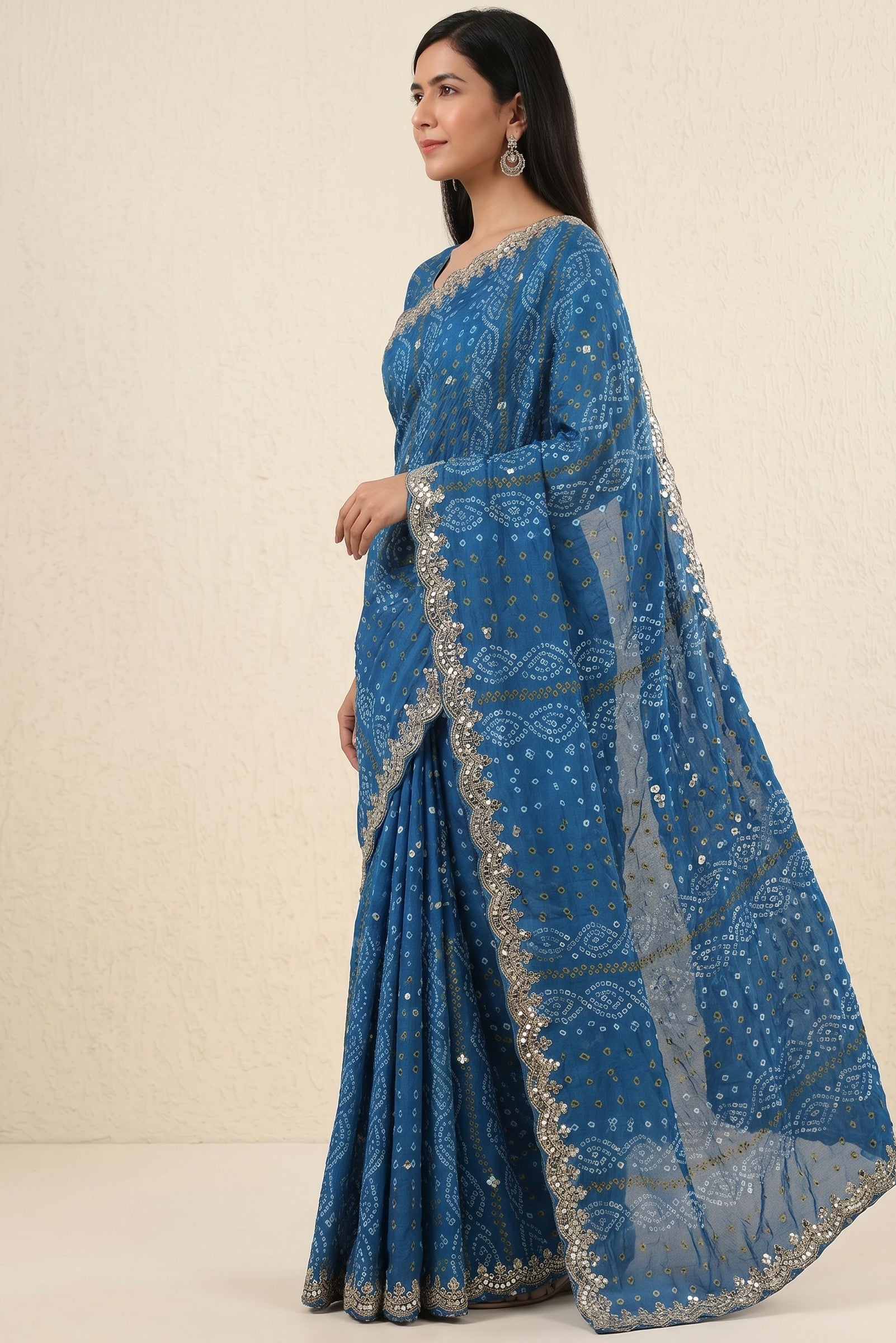 Rangoli blue georgette saree with traditional bandhani print and sequin mirror work border. Model wearing ethnic attire.