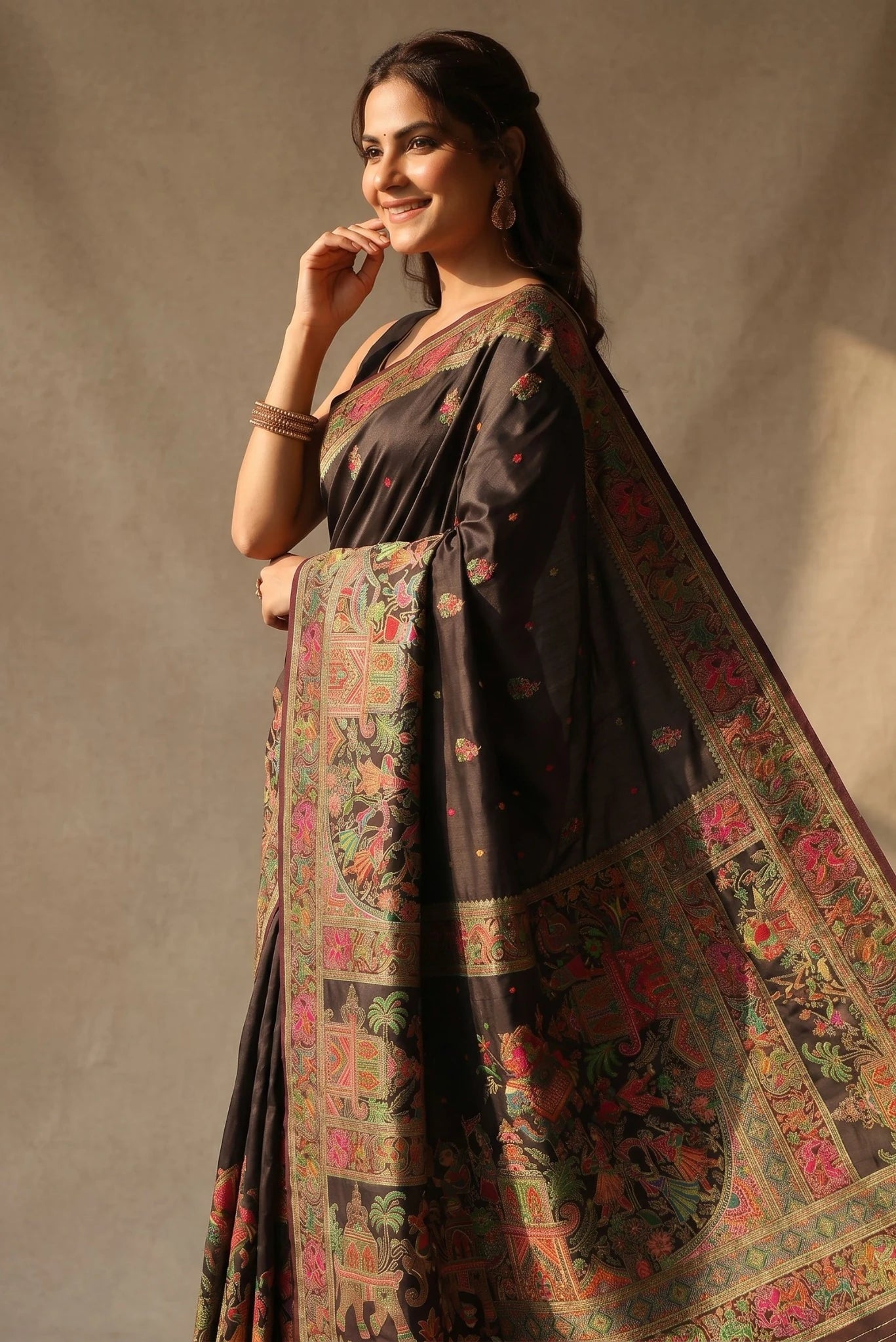 Woman wearing a traditional saree with a floral pattern against a plain background