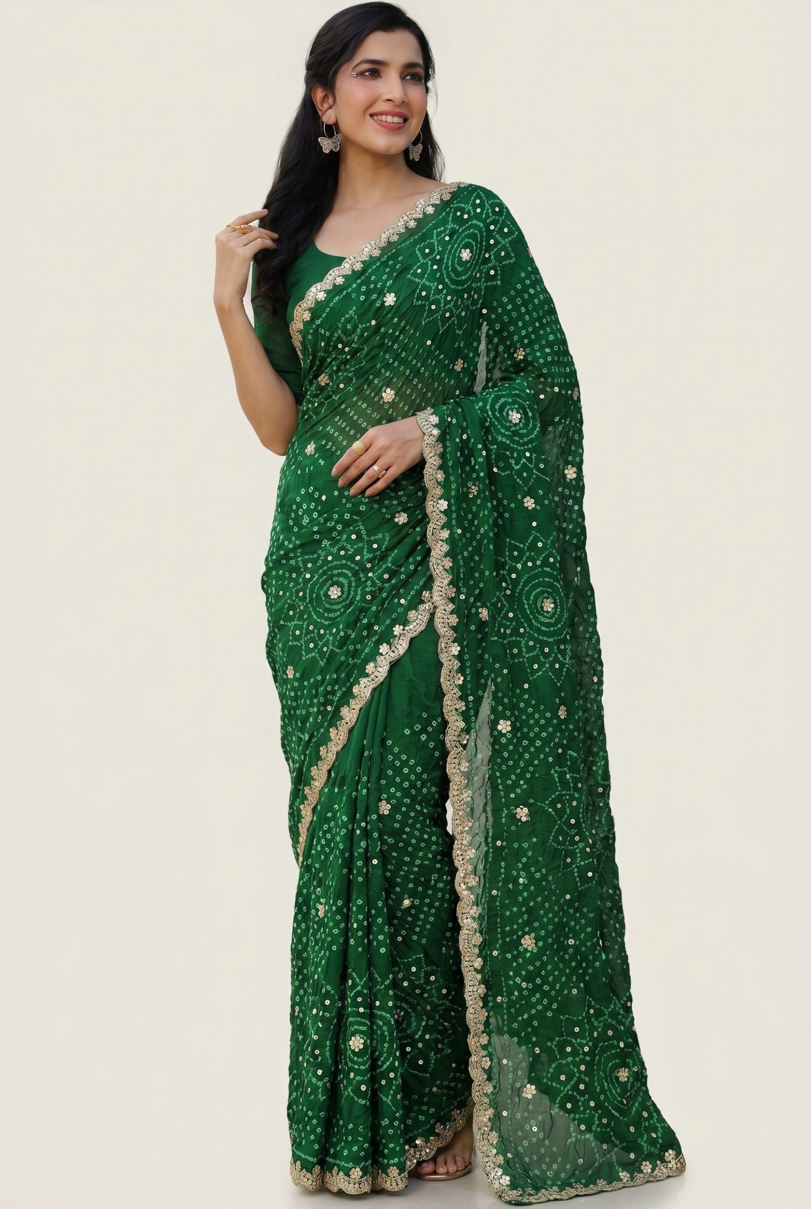 Rangoli emerald green georgette saree with bandhani tie-dye and sequin embellishments, featuring a golden lace border.