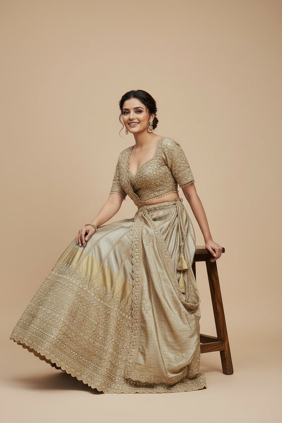 Rangoli embellished golden silk lehenga set with dupatta. Features intricate embroidery and shimmering embellishments.