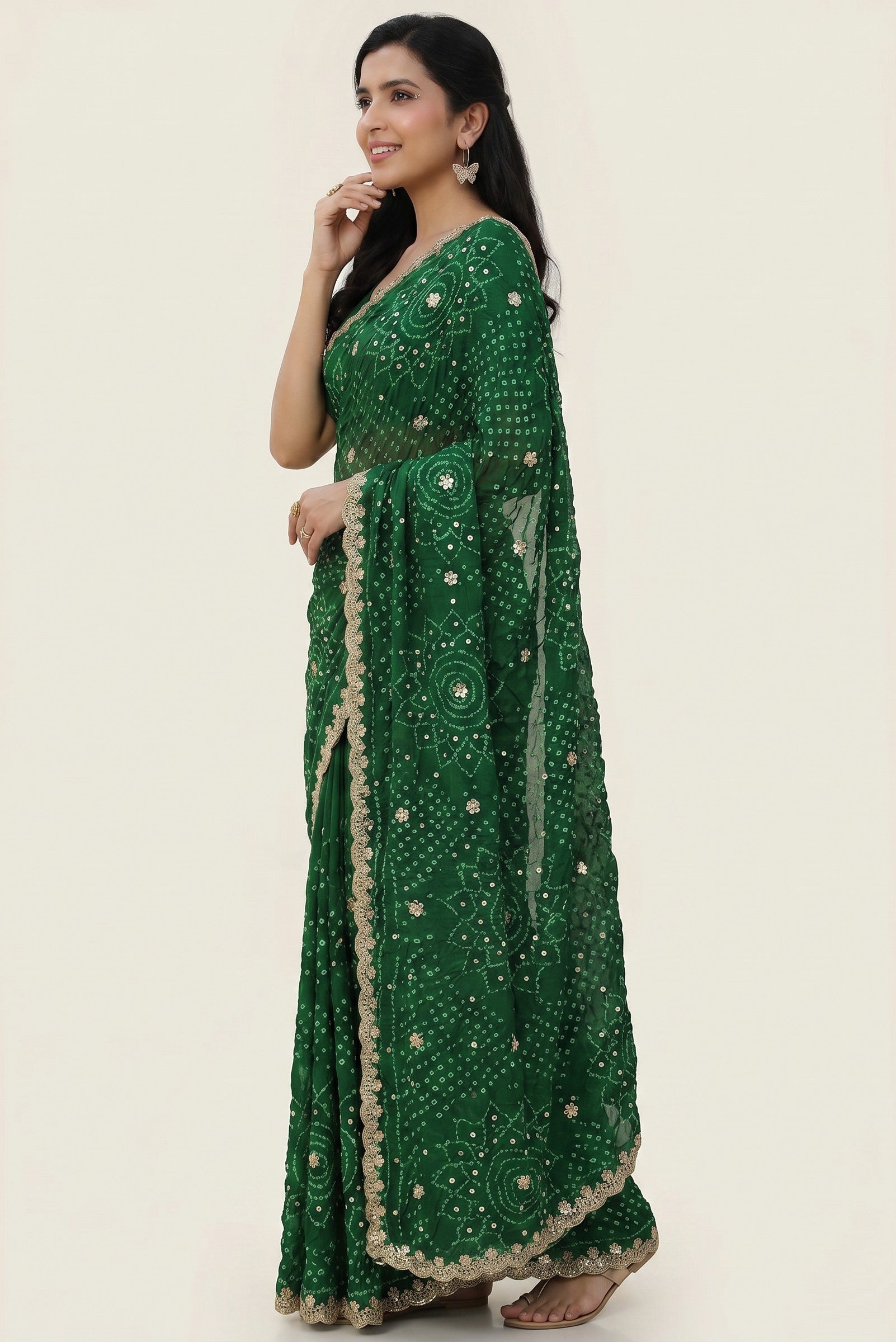 Rangoli emerald green georgette saree with bandhani tie-dye and sequin embellishments, featuring a golden lace border.