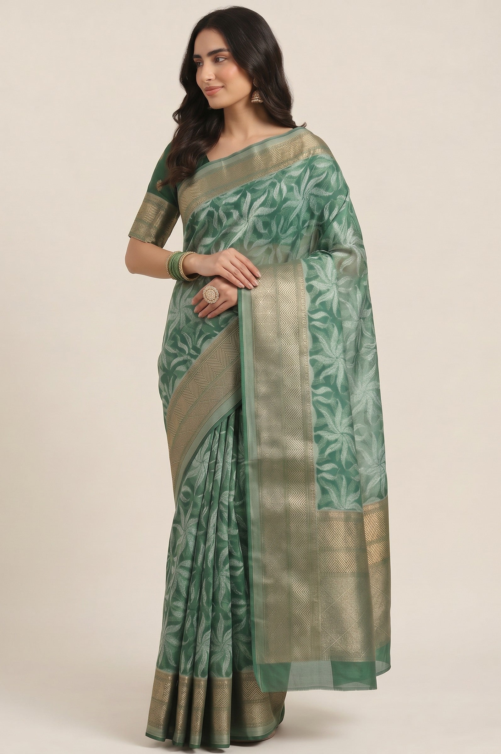 Rangoli women's green Kanjeevaram silk saree with all-over white floral motif and golden border. Elegant ethnic wear.