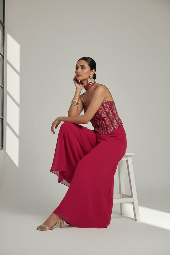 Rangoli magenta georgette palazzo pant set with embroidered sleeveless crop top and choker neckline.