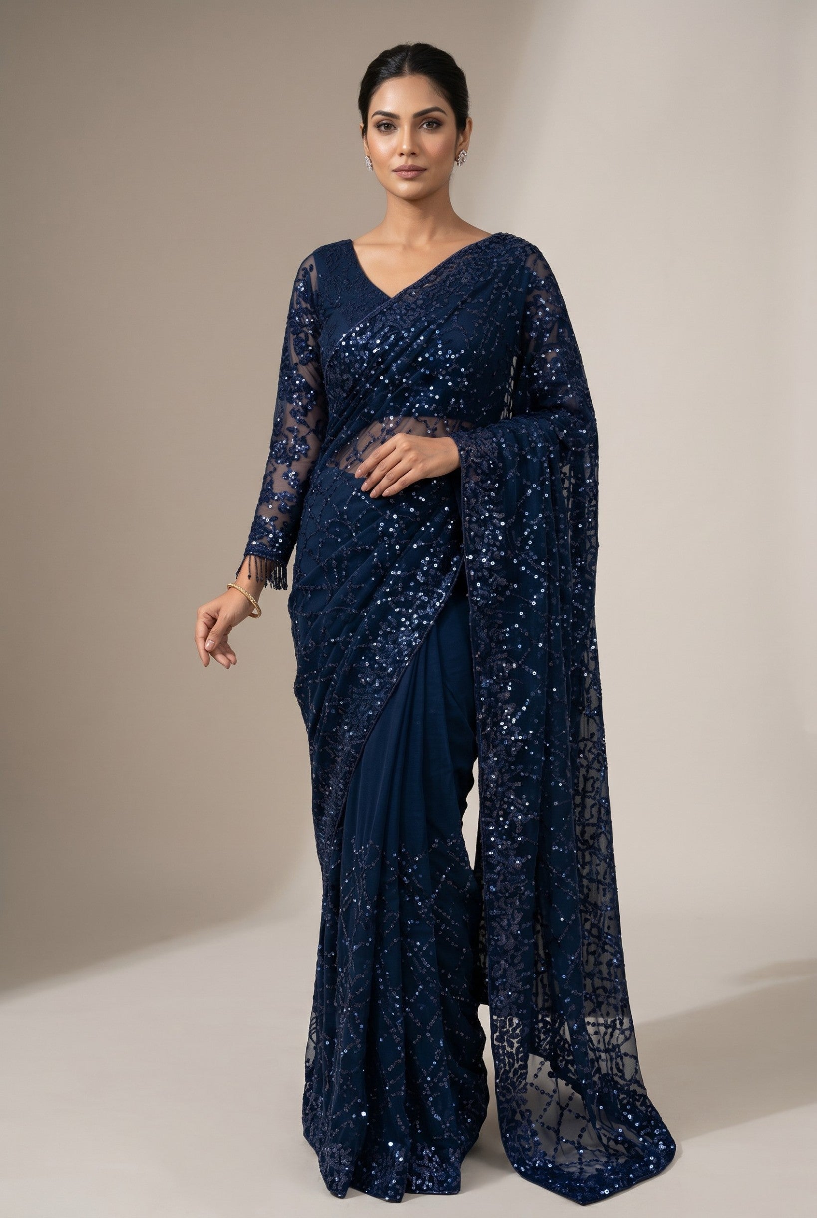 Rangoli navy blue net saree with full sleeves blouse, adorned with intricate sequin embellishments for a glamorous look.
