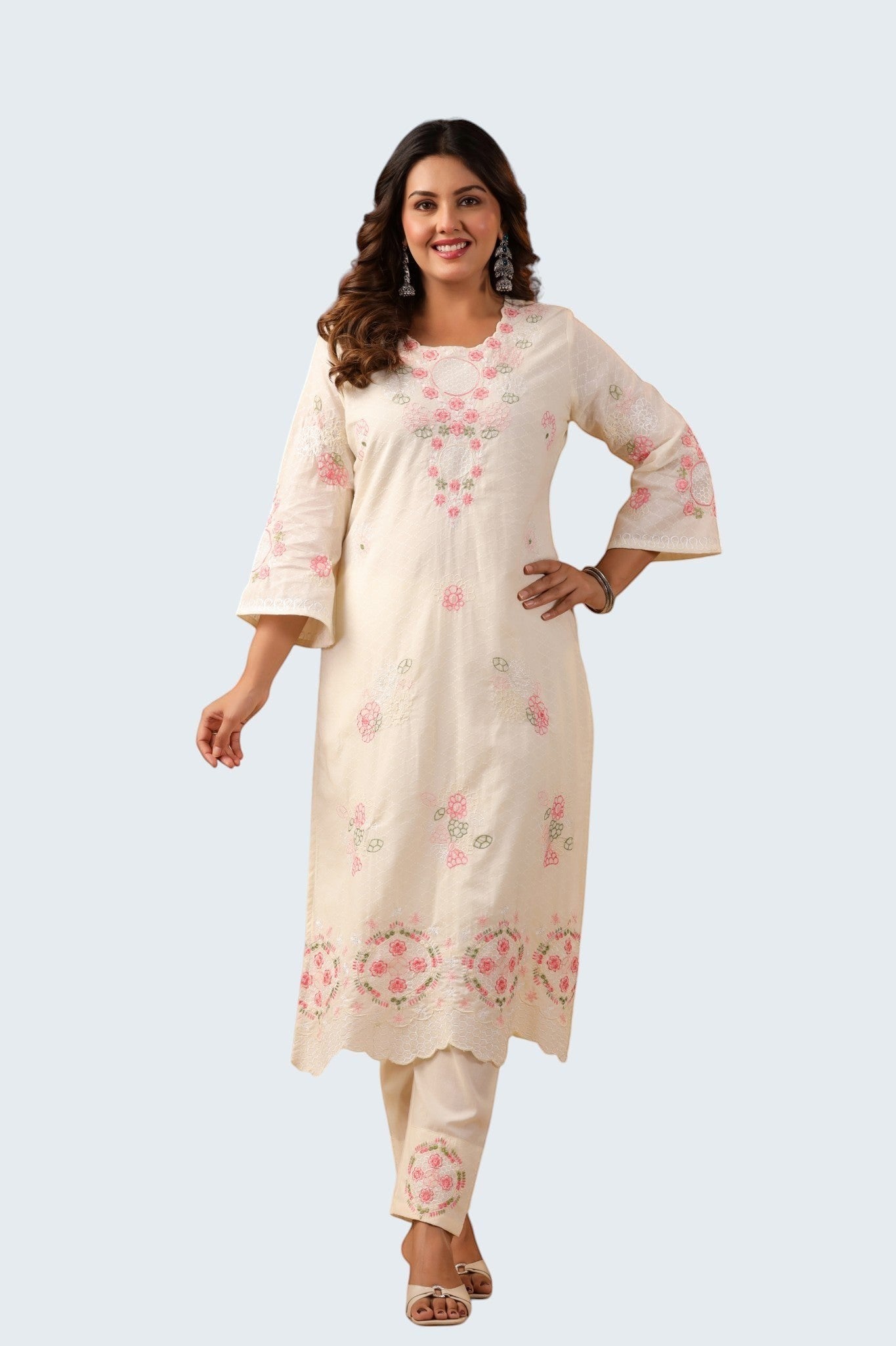 Rangoli off white cotton suit with pink floral embroidery on neckline, sleeves, and hem. Includes trousers.