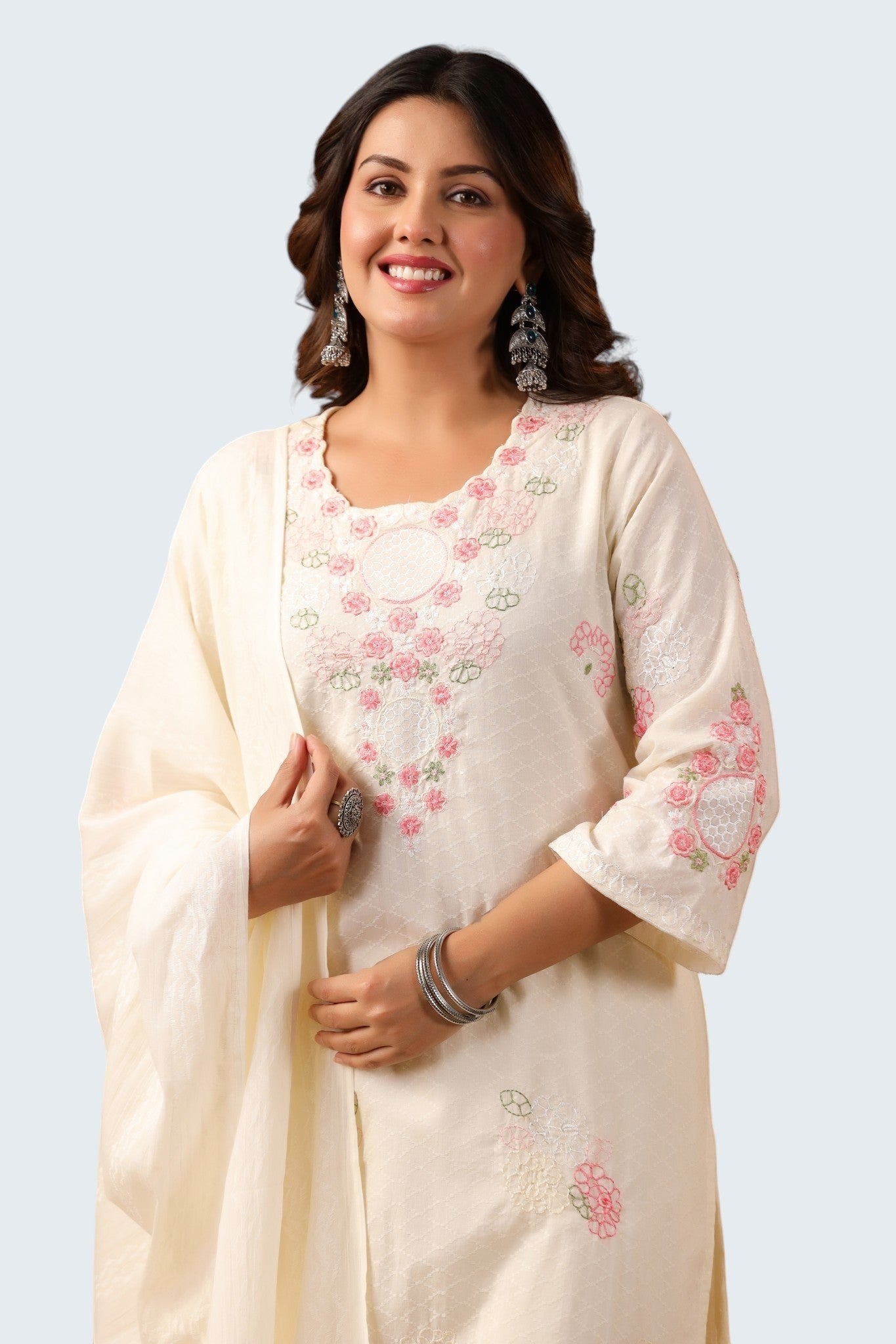 Rangoli off white cotton suit with pink floral embroidery on neckline, sleeves, and hem. Includes dupatta and trousers.