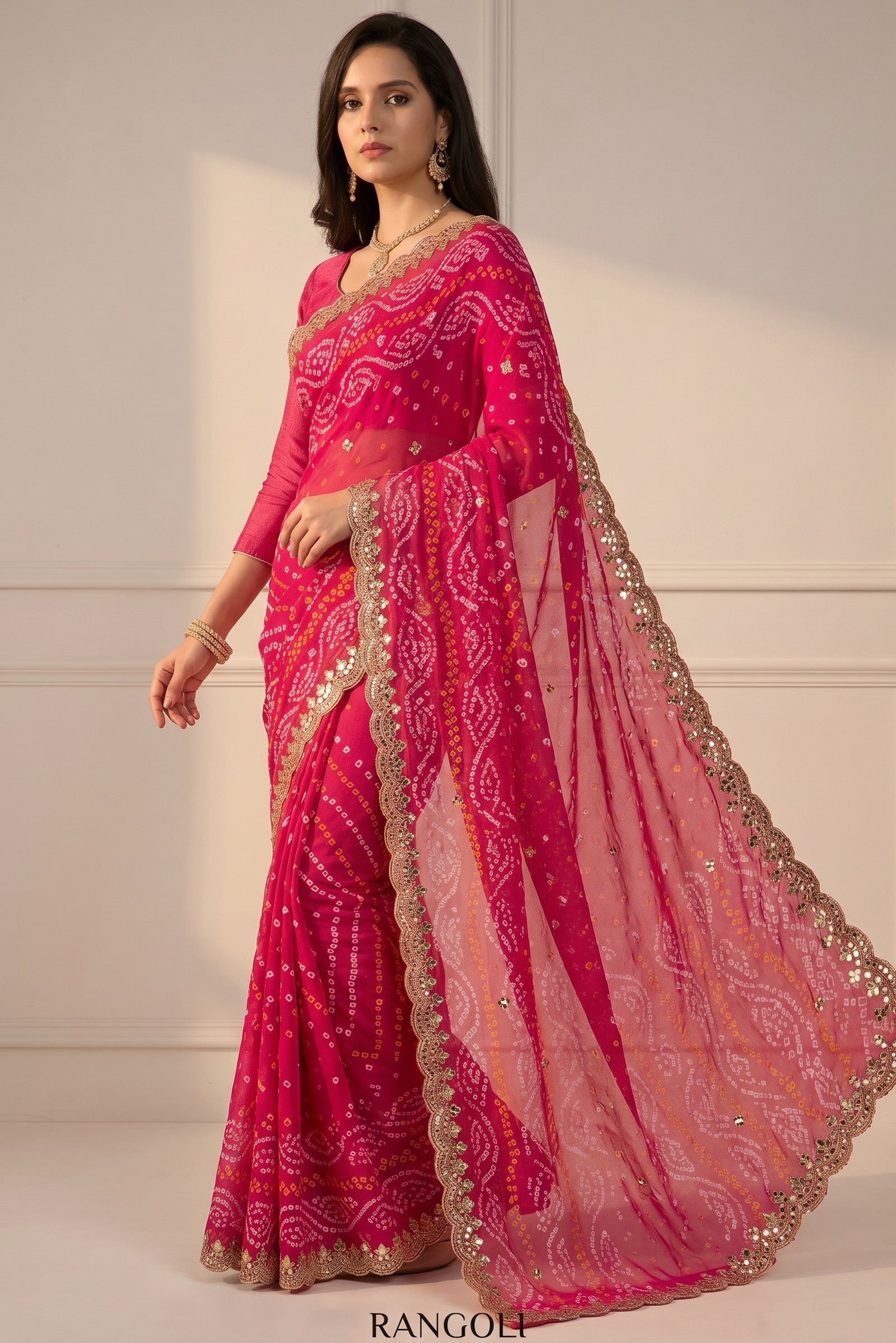 Rangoli pink silk saree with white and yellow bandhani tie-dye, golden zari border, and sequin embellishments.