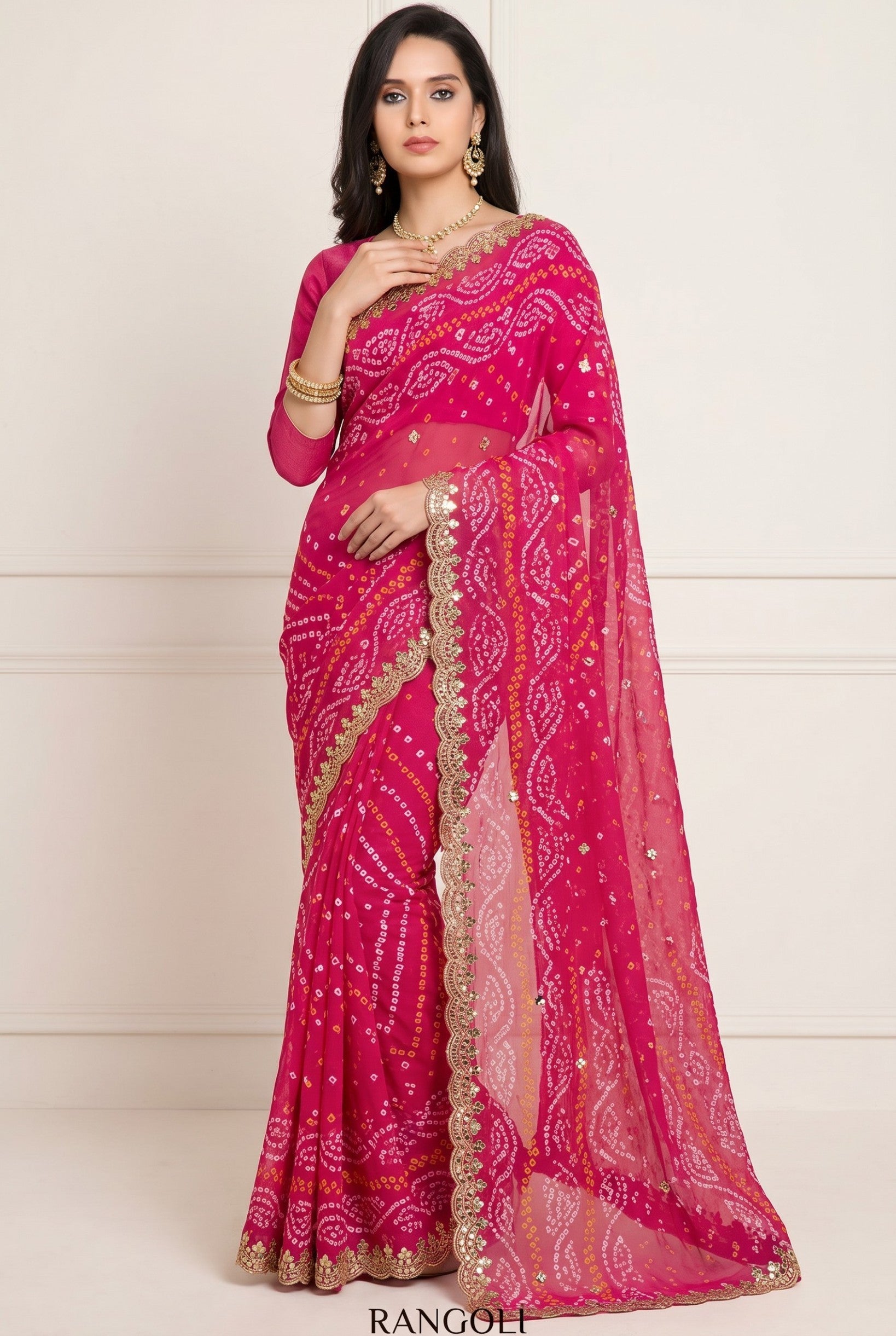 Rangoli pink silk bandhani saree with white and yellow tie-dye, golden zari border, and sequin embellishments.