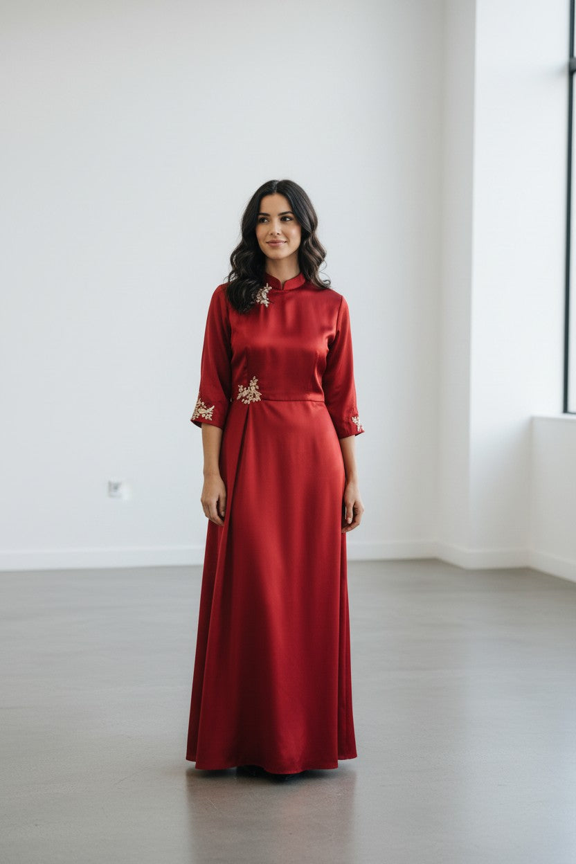 Rangoli red satin maxi dress with mandarin collar and gold embroidery on neckline and sleeves.