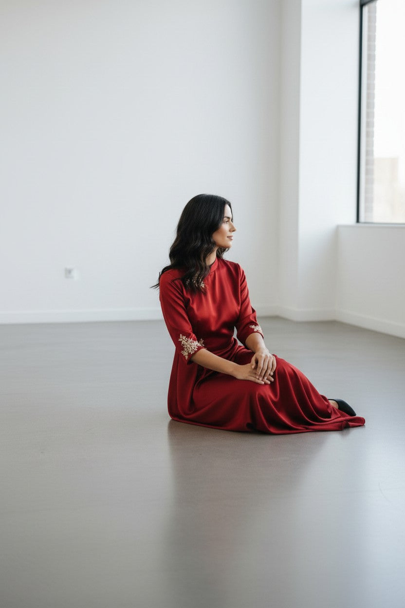 Rangoli red satin maxi dress with mandarin collar and gold embroidery on neckline and sleeves. Floor-length gown for formal events.