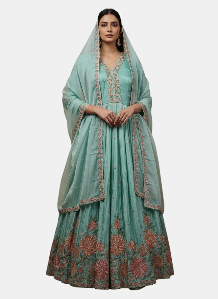 Rangoli teal silk Anarkali suit with floral embroidery and dupatta. Perfect for festive occasions.