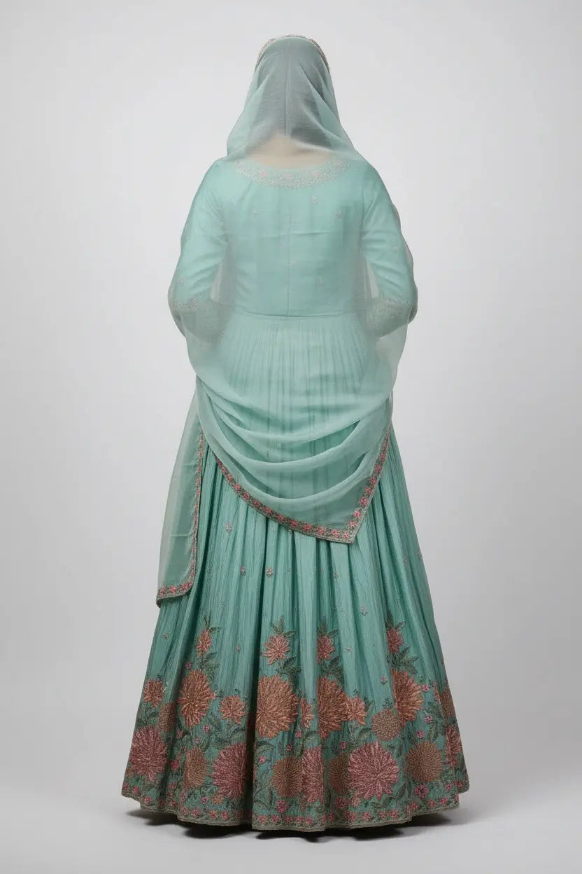 Light blue traditional outfit with floral patterns on a white background