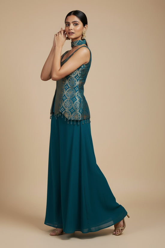 Rangoli teal sleeveless peplum top with gold brocade and tassels, paired with flowing palazzo pants. V-neckline.