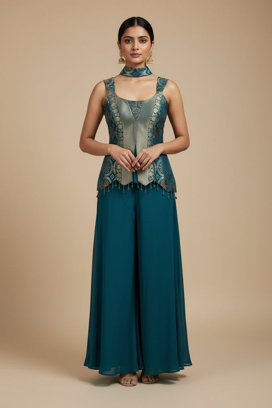 Rangoli teal sleeveless peplum top with gold brocade and tassels, paired with flowing palazzo pants. V-neckline and choker.