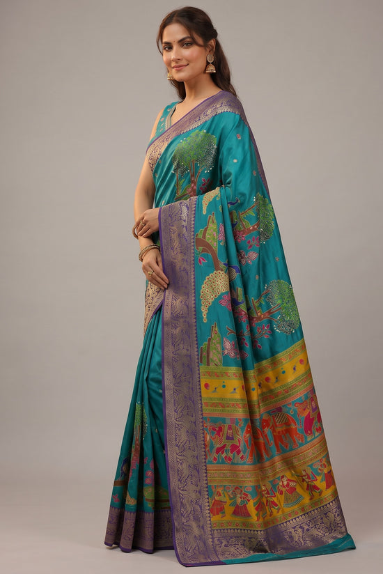 Rangoli teal silk saree with intricate purple border, featuring whimsical trees, animals, and human figures. Subtle embellishments.