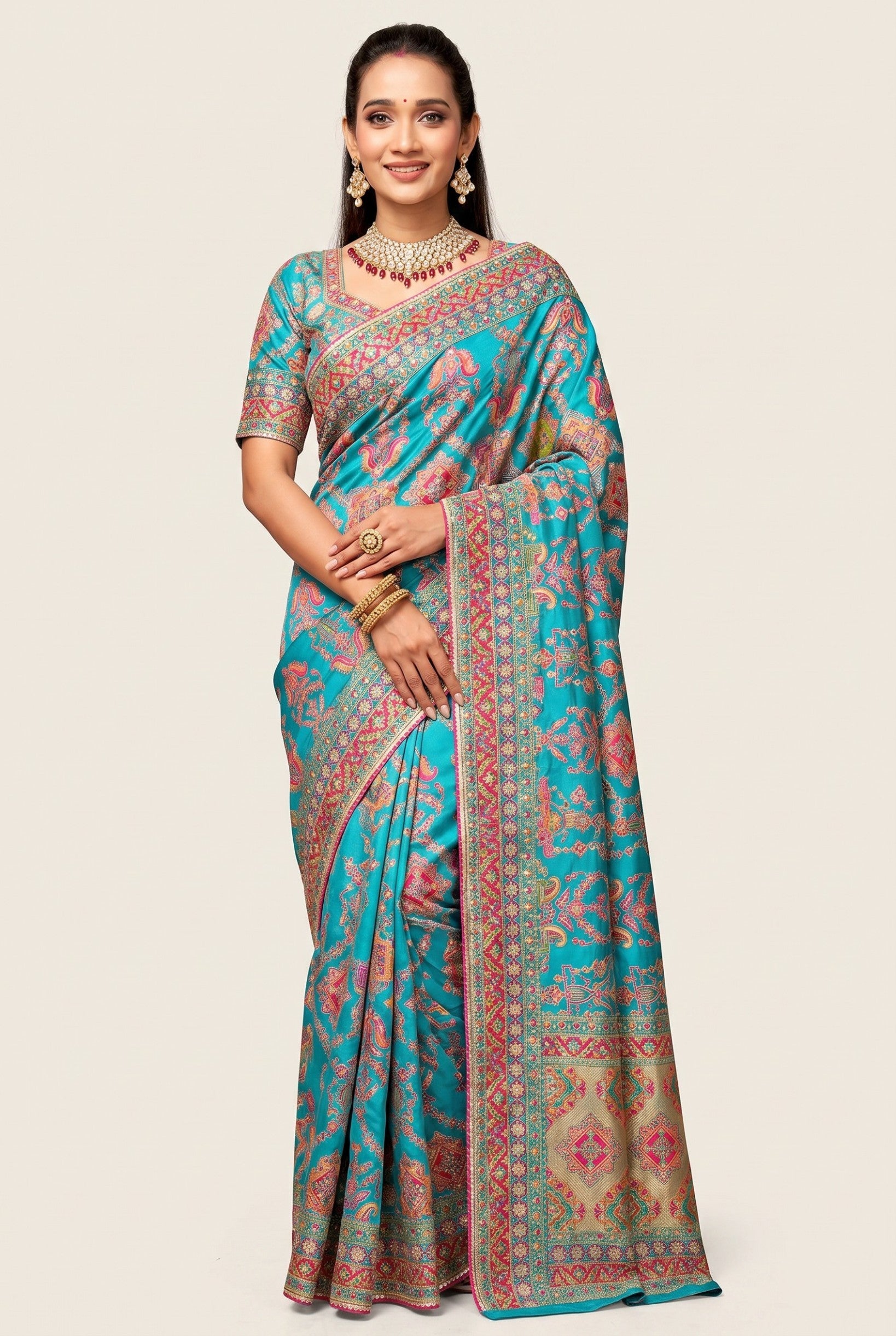 Rangoli teal silk saree with intricate paisley motifs, detailed border, and matching blouse. Perfect for special occasions.