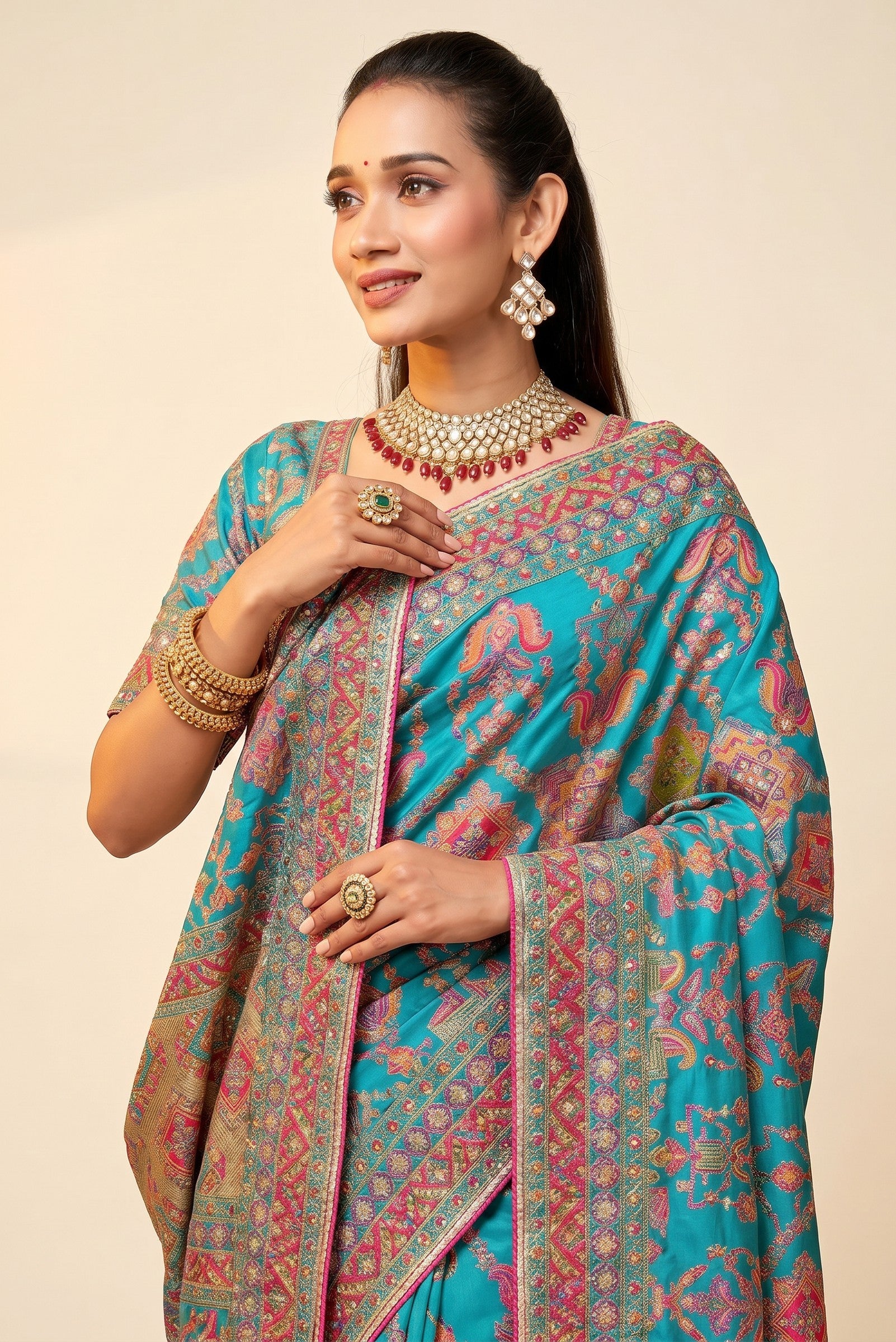 Rangoli teal silk saree with intricate paisley motifs, detailed border, and matching blouse. Perfect for special occasions.