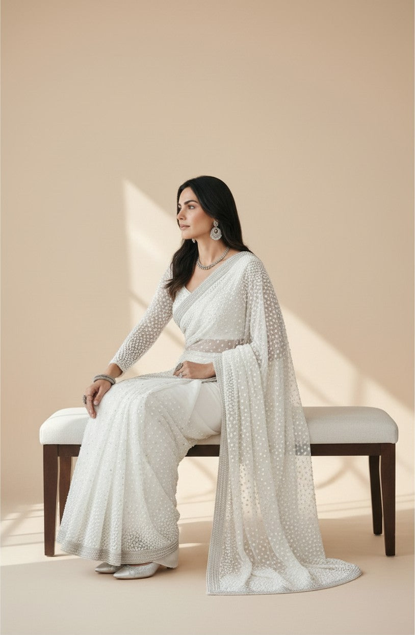 Rangoli white georgette saree with pearl and sequin embellishments and sheer sleeves, worn by a model.