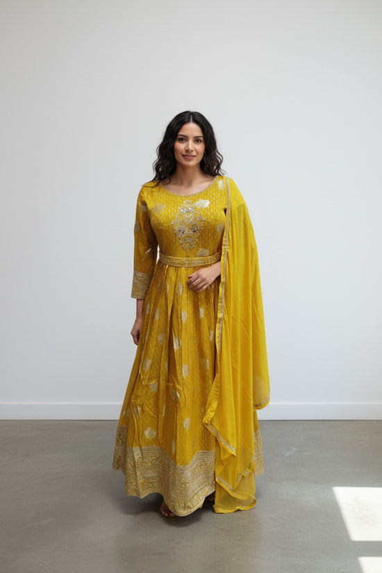 Rangoli yellow Anarkali suit with golden embroidery, three-quarter sleeves, and dupatta. Perfect for festive occasions.