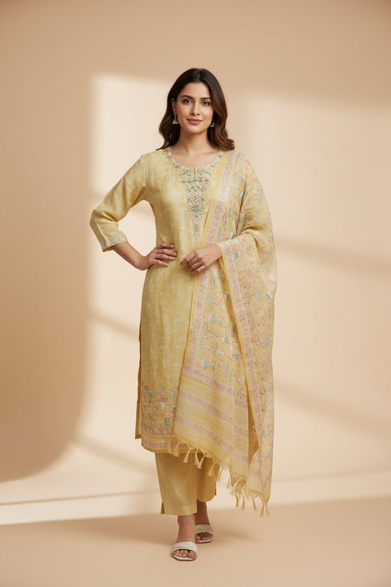 Rangoli yellow silk kurta set with embroidered neckline and hem, matching pants, and printed dupatta with tassel border.