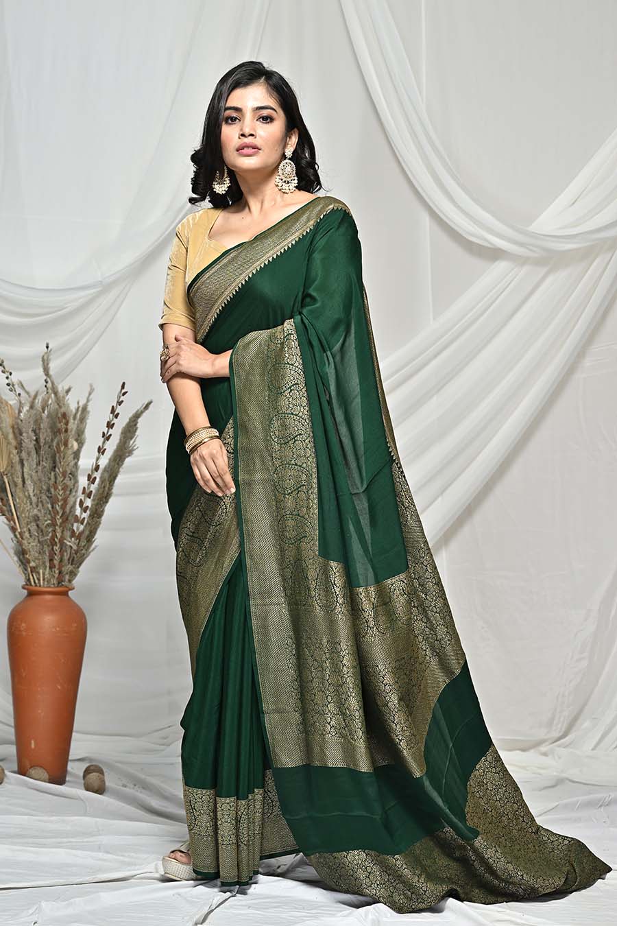 Bottle green color soft georgette saree with zari weaving work